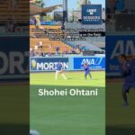 Shohei Ohtani protects himself from a batting practice ball on the field at Dodger Stadium.