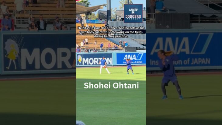 Shohei Ohtani protects himself from a batting practice ball on the field at Dodger Stadium.