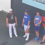 Shohei Ohtani throwing and Yoshinobu Yamamoto in the bullpen.